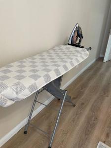 a bed in a room with a checkered table at 3 bedroom apartment with 2 restroom in the Ala Park Business class in Almaty