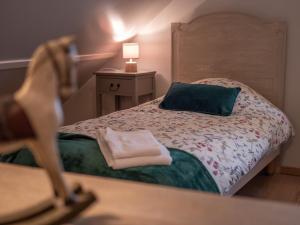 a small bedroom with a bed and a mirror at Le P'tit Louis in Saint-Cyr-les-Colons