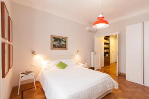 ローマにあるLovely House Romeの白いベッドルーム(緑の枕と大きな白いベッド付)