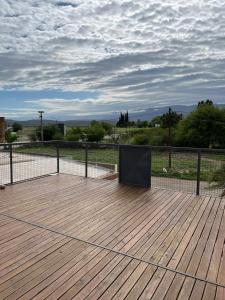 a wooden deck with a tv on top of it at Complejo Aloe Vera C in Villa Dolores