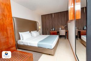 Krevet ili kreveti u jedinici u okviru objekta Hotel Terminus Maputo