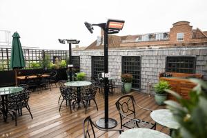 a patio with tables and chairs on a deck at Teller's Arms in Farnham