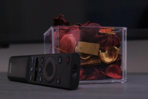 a remote control sitting next to a container of food at Porto Antico Apartment in Genoa