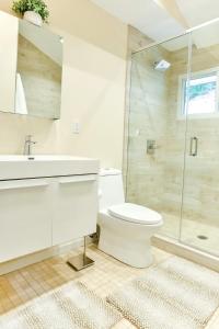 a white bathroom with a toilet and a shower at Relaxation Retreat Home with Hot Tub Gym & Sauna in Prattsville +24 photos