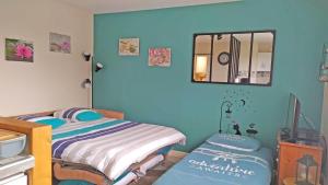 a small bedroom with a bed and a mirror at a lovely nest in Bussy-Saint-Georges +22 photos