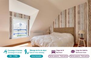 a bedroom with a bed and a window at Maison de pierre pour 8 avec beau jardin in Saint-Gildas-de-Rhuys