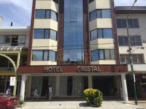 a hotel on a street with people walking in front of it at Hotel Cristal in San Carlos de Bariloche