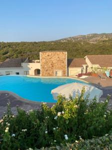 a swimming pool in a villa with mountains in the background at Casa Stella Residence Ea Bianca Baja Sardinia in Baja Sardinia