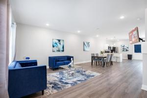 a living room with a blue couch and a table at Waiting to Excell in Clarksville
