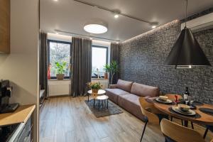 a living room with a couch and a table at Apartamenty Częstochowa pod Jasną Górą Teresy 4-2 parking gratis in Częstochowa