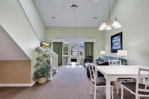 a living room with a table and a couch at Pelicans Reef by the beach in Myrtle Beach