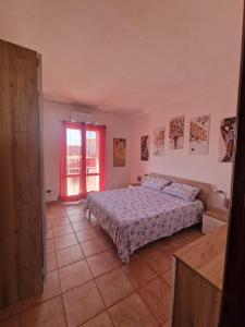 a large bedroom with a bed and a window at Casa Marina in Tortolì
