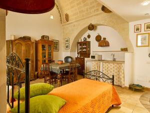 a bedroom with a bed and a kitchen with a table at Sax Barisano in Matera