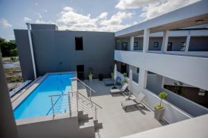a balcony of a building with a swimming pool at 108 The Meadows in George
