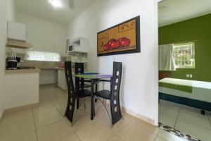 a kitchen with a table and chairs in a room at Casa Mia in Puerto Escondido