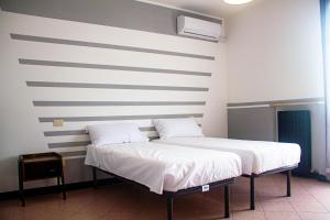 Postel nebo postele na pokoji v ubytování Camere della Perla