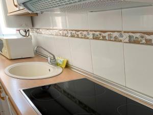 a small kitchen with a sink and a counter top at Apartamentos Mar Bella Segur de Calafell 3000 in Segur de Calafell +41 photos