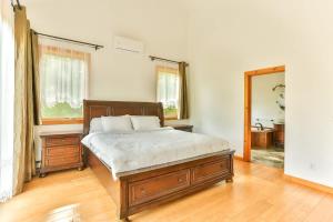 a bedroom with a large bed and a mirror at Stunning Home with Hot Tub Fire Pit & Amazing Views in Hunter