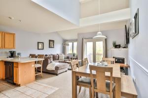 a kitchen and living room with a table and chairs at Spacious 3 BR Condo Steps Away From Slopes in Hunter