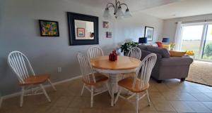 a living room with a table and chairs and a couch at Sunny Spot, Best Views in St. Helena Island