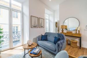 a living room with a blue couch and a table at Varanda Azul - First Mate Loft (City Centre) in Ponta Delgada