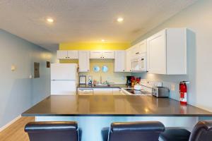a kitchen with white cabinets and a counter top at Coastal Tranquility in Neskowin
