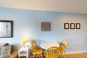 a dining room with a white table and chairs at Coastal Tranquility in Neskowin
