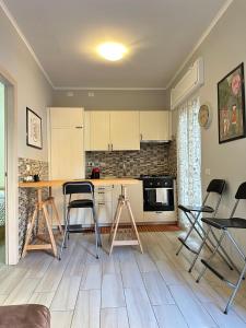 a kitchen with a counter and chairs in a room at Casina dei Gemelli in Rome