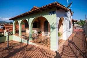 a small house with a porch and a roof at Espaço Mônica Hospedagem in Brumadinho