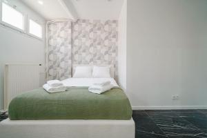 a bedroom with a bed with two towels on it at Appartement Mairie des Lilas - IV in Les Lilas