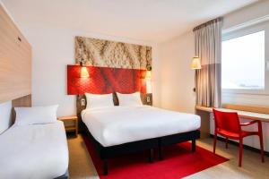Postel nebo postele na pokoji v ubytování B&B HOTEL Mons Gare