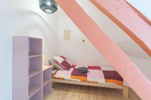 Un dormitorio con una cama en un ático en "Côte d'eau" Au cœur de la vieille ville - Appartements, en Boulogne-sur-Mer