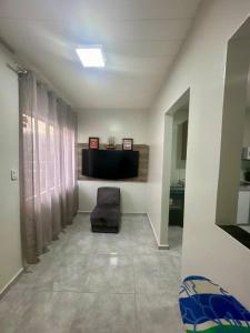 a living room with a chair in a room at Apto completo a alguns metros do Shopping Macapá in Macapá +4 photos