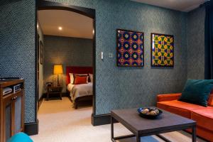 a living room with a room with a bed and a mirror at Fox and Anchor in London +23 photos