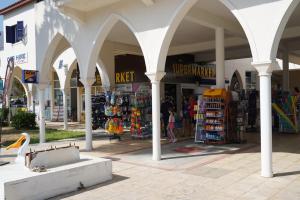 a shopping center with arches and stores in a mall at Casa Luna Luxurious comfy seaside 3persons apt in Paphos
