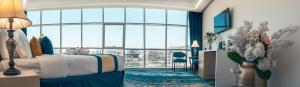 a hotel room with a bed and a large window at Taj Park Hotel in Mecca +99 photos