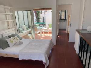 a bedroom with a bed and a view of a patio at Casa pintora Neus in Cadaqués