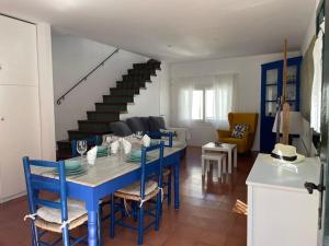a blue table and chairs in a living room at Casa pintora Neus in Cadaqués