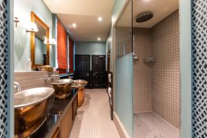 a bathroom with three sinks and a shower at Fox and Anchor in London +23 photos