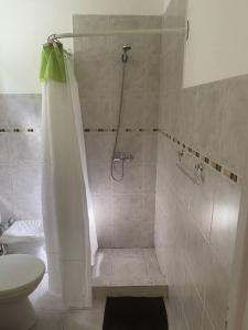 a bathroom with a shower and a toilet at Casita María in Puerto San Julián +18 photos