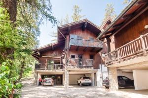 a house with cars parked in front of it at Parcheggio-Camino-WiFi - Chalet immerso nella Natura in Courmayeur