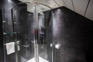 a shower with a glass door in a bathroom at Vacant Nests - The Ocean Retreat in South Shields +31 photos