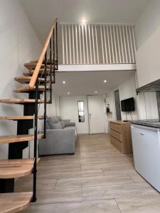 a kitchen and a living room with a spiral staircase at Studio Roma - Jean Médecin - LA RIVIERA LCD in Nice