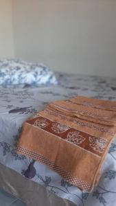 two mats sitting on top of a bed at Loft Temporada Praia do Meio in Natal +22 photos