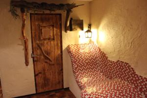 a room with a bed with a lamp and a door at Ferienwohnung Lasshofer in Sankt Michael im Lungau