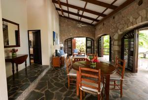 a dining room with a table and chairs at Stonefield Villa Resort in Soufrière