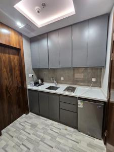 a kitchen with white cabinets and a sink in it at شقق اعمار الديار للشقق المخدومة in Jeddah +56 photos