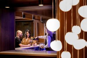 a group of people standing in front of a mirror at Hotel Corona in Pescasseroli
