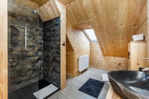 a bathroom with a black sink and wooden walls at Willa Ciżemka- sauna, tężnia solankowa in Bukowina Tatrzańska +116 photos