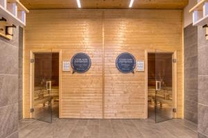 a room with three signs on a wall at COOEE alpin Hotel Bad Kleinkirchheim in Bad Kleinkirchheim